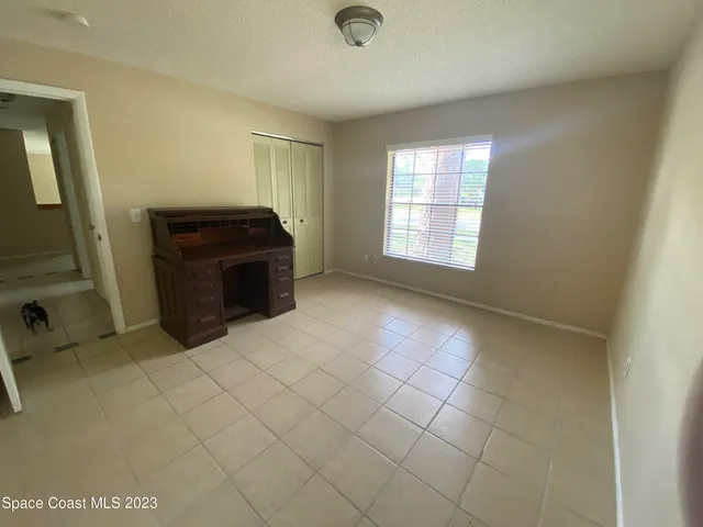 a view of a livingroom with an empty space and a window