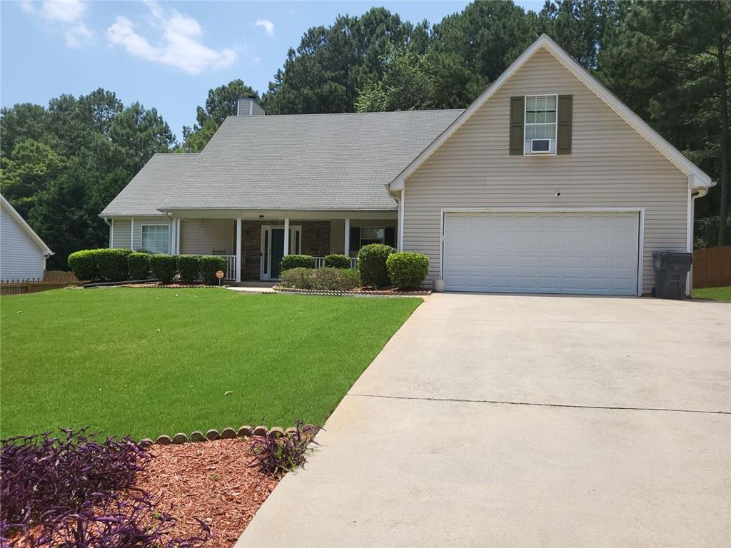 a front view of house with yard and green space