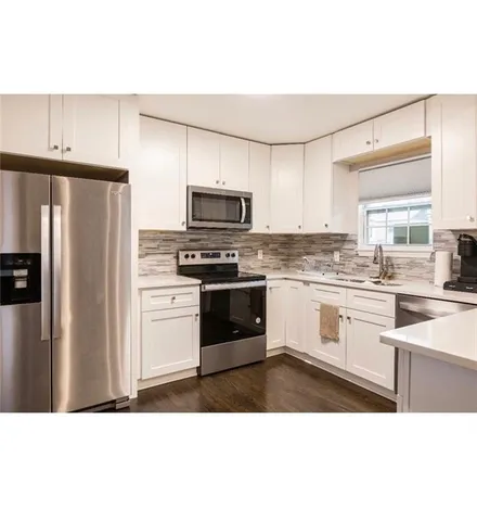 a kitchen with stainless steel appliances a refrigerator stove and sink