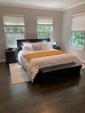 a bed sitting in a bedroom next to a window