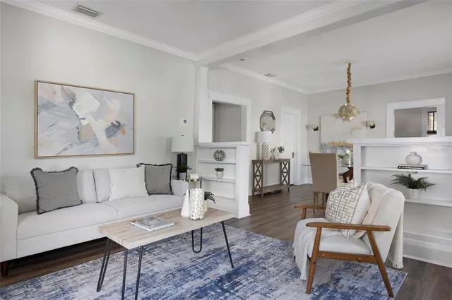 a living room with furniture and a dining table