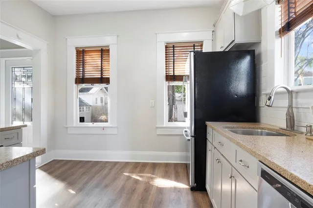 a kitchen with stainless steel appliances granite countertop a refrigerator and a sink