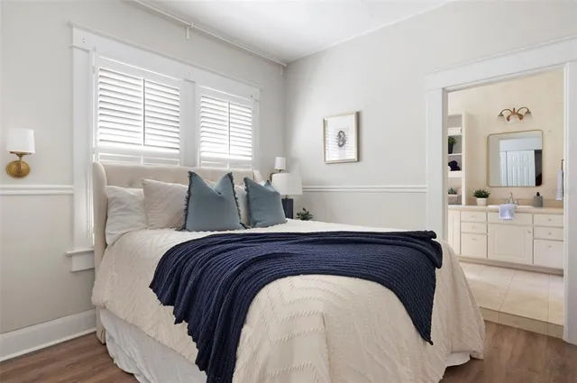 a bed sitting in a bedroom next to a window