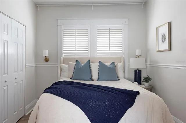 a bedroom with a large bed and a window