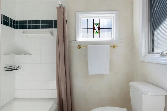 a white toilet sitting next to a bathroom sink