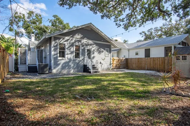 a backyard of a house with barbeque oven and outdoor seating