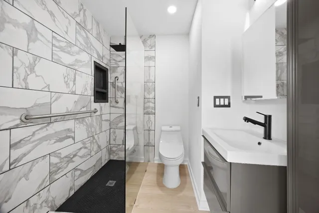 a bathroom with a glass shower door and a toilet