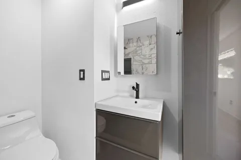 a bathroom with a sink toilet and shower
