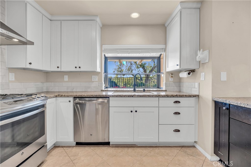 21390 Vía Del Parque Yorba Linda, CA 92887 - Photo 11 of 42 a kitchen with granite countertop white cabinets and white appliances