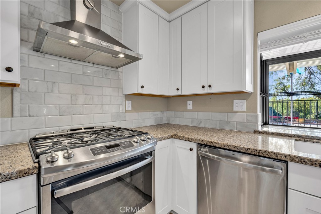 21390 Vía Del Parque Yorba Linda, CA 92887 - Photo 13 of 42 a kitchen with granite countertop a stove sink and cabinets