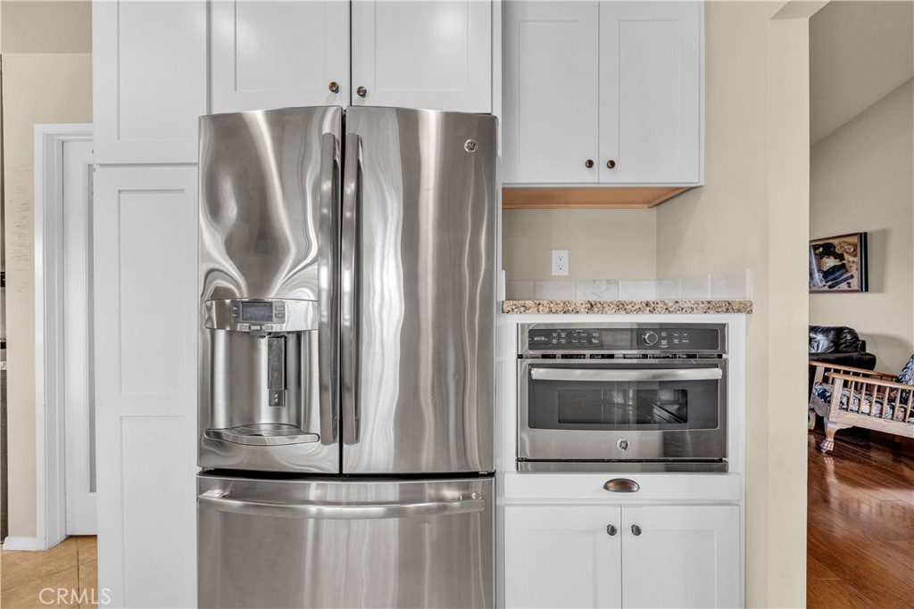 21390 Vía Del Parque Yorba Linda, CA 92887 - Photo 14 of 42 a kitchen with granite countertop a refrigerator and a stove top oven