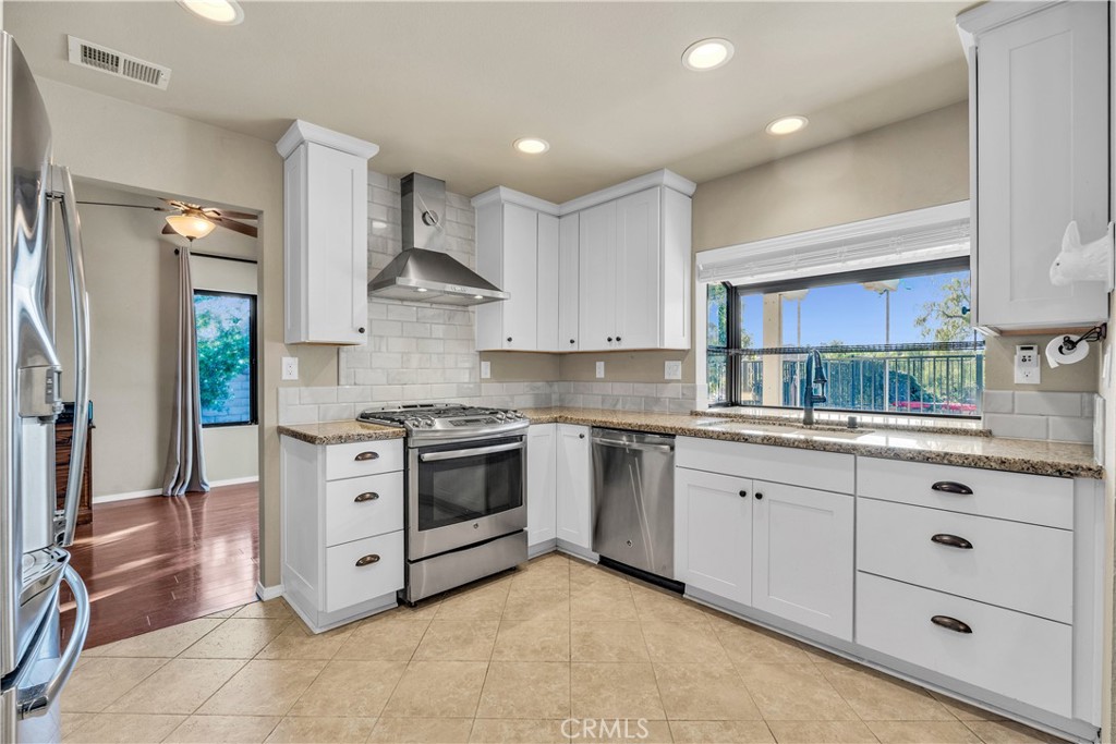 21390 Vía Del Parque Yorba Linda, CA 92887 - Photo 15 of 42 a kitchen with granite countertop a sink stainless steel appliances and cabinets