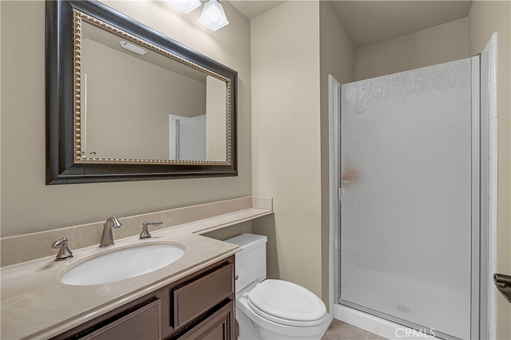21390 Vía Del Parque Yorba Linda, CA 92887 - Photo 19 of 42 a bathroom with a toilet a sink and mirror