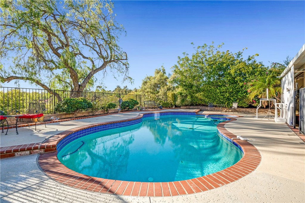 21390 Vía Del Parque Yorba Linda, CA 92887 - Photo 2 of 42 a view of a swimming pool with an outdoor space and seating area