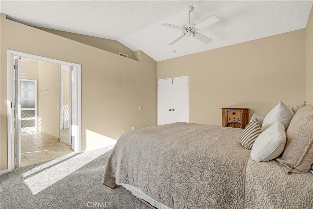 21390 Vía Del Parque Yorba Linda, CA 92887 - Photo 23 of 42 a bed room with a bed and a chandelier