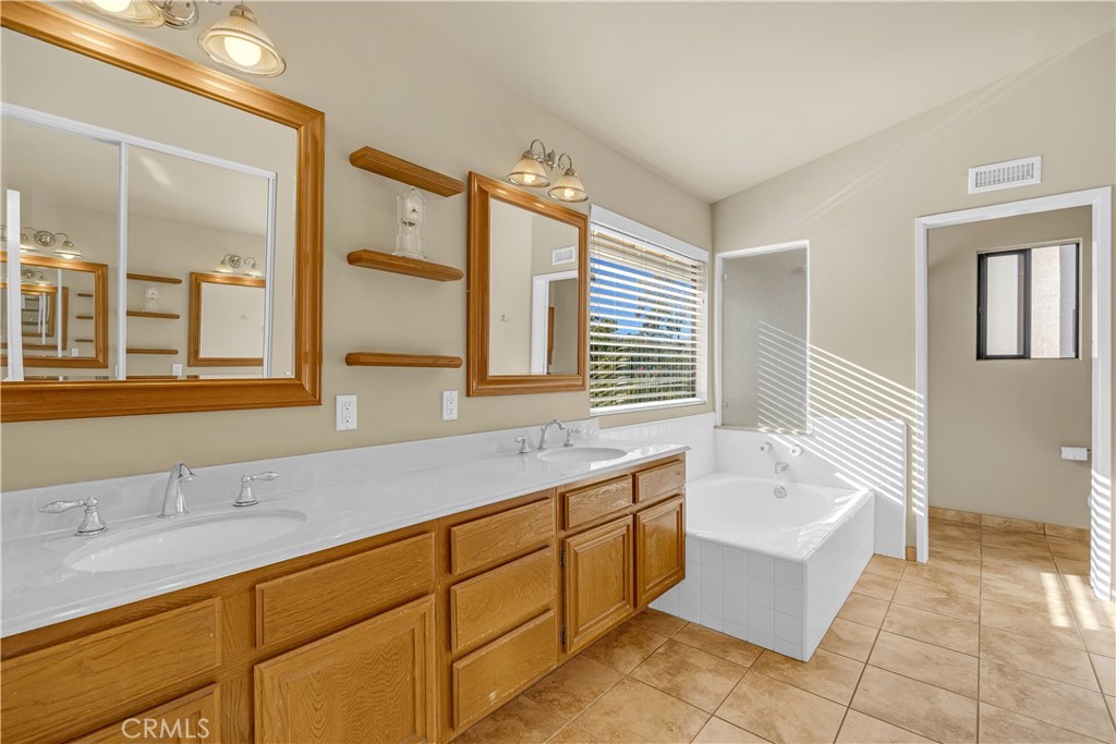 21390 Vía Del Parque Yorba Linda, CA 92887 - Photo 24 of 42 a spacious bathroom with a tub sink and mirror