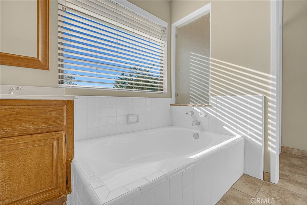 21390 Vía Del Parque Yorba Linda, CA 92887 - Photo 25 of 42 a bathroom with a bathtub and a shower