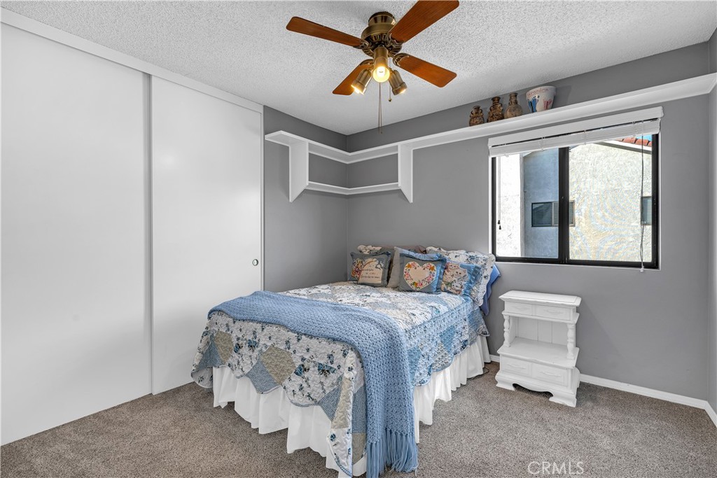 21390 Vía Del Parque Yorba Linda, CA 92887 - Photo 26 of 42 a bedroom with a bed and a chandelier