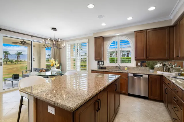 a kitchen with center island and large windows