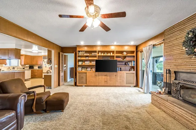 a kitchen with a refrigerator a sink and dishwasher with white cabinets