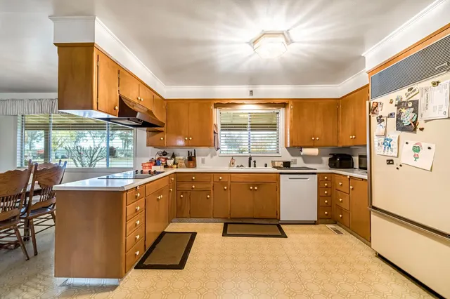 a kitchen with refrigerator and cabinets