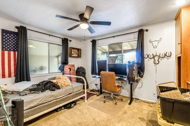 a bedroom with a bed and a chandelier