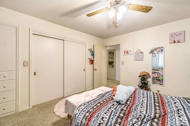 a view of a hallway with wooden shelves