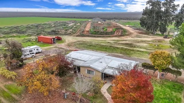 an aerial view of a house with a yard
