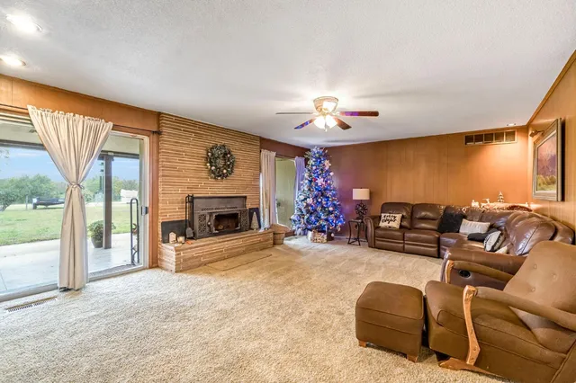 a view of a livingroom with furniture and a ceiling fan