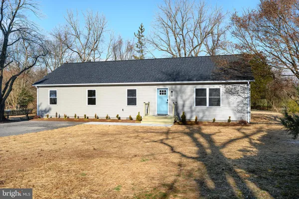 front view of a house with a large tree