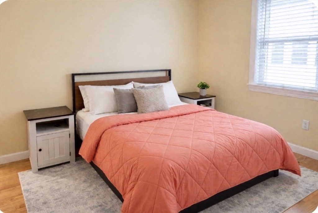 17 Proctor Street Peabody, MA 01960 - Photo 8 of 13 a bed sitting in a bedroom next to a window