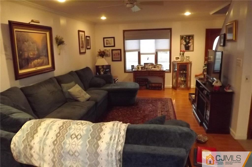 93 Magnolia Road Iselin, NJ 08830 - Photo 2 of 25 a living room with furniture and a flat screen tv