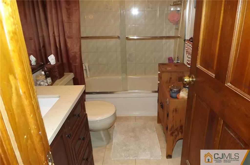 93 Magnolia Road Iselin, NJ 08830 - Photo 14 of 25 a bathroom with a sink a toilet and shower