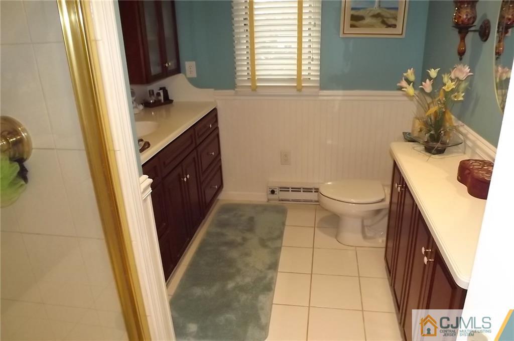93 Magnolia Road Iselin, NJ 08830 - Photo 17 of 25 a bathroom with a sink a toilet and a tub