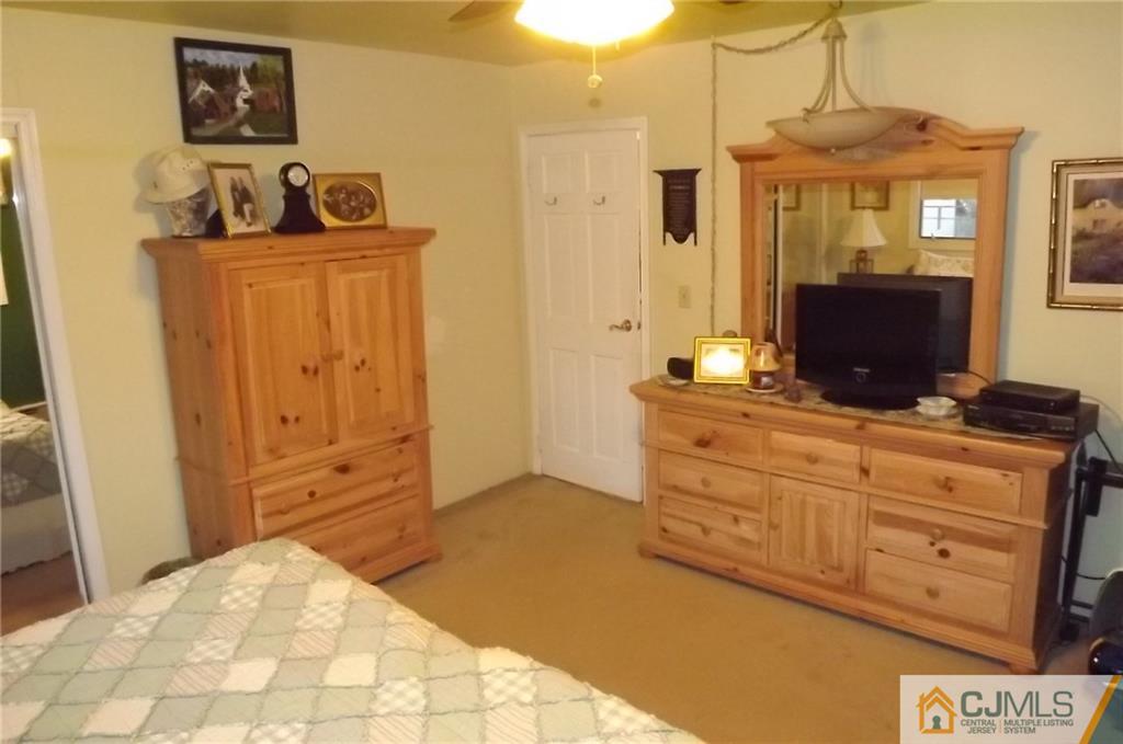 93 Magnolia Road Iselin, NJ 08830 - Photo 20 of 25 a bedroom with a bed and a dresser in it