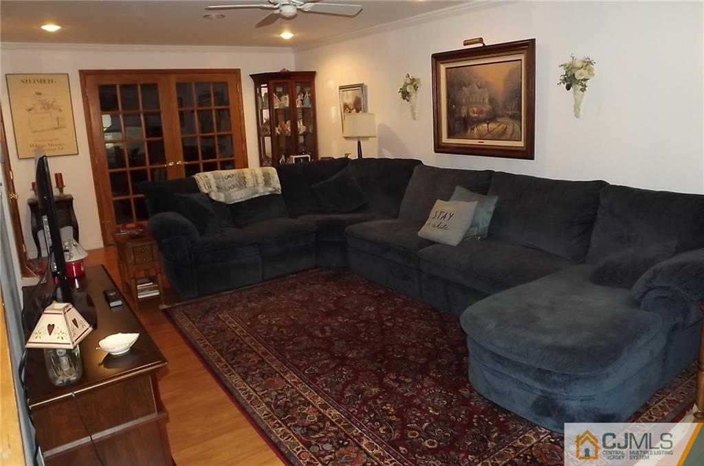 93 Magnolia Road Iselin, NJ 08830 - Photo 3 of 25 a living room with furniture and a rug