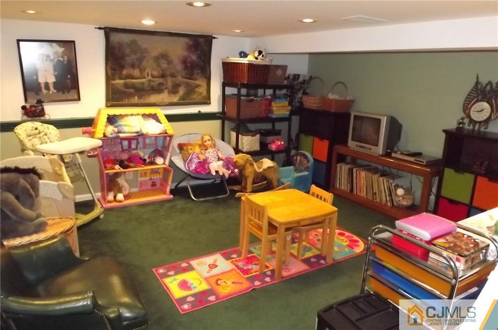 93 Magnolia Road Iselin, NJ 08830 - Photo 22 of 25 a living room with furniture and a flat screen tv