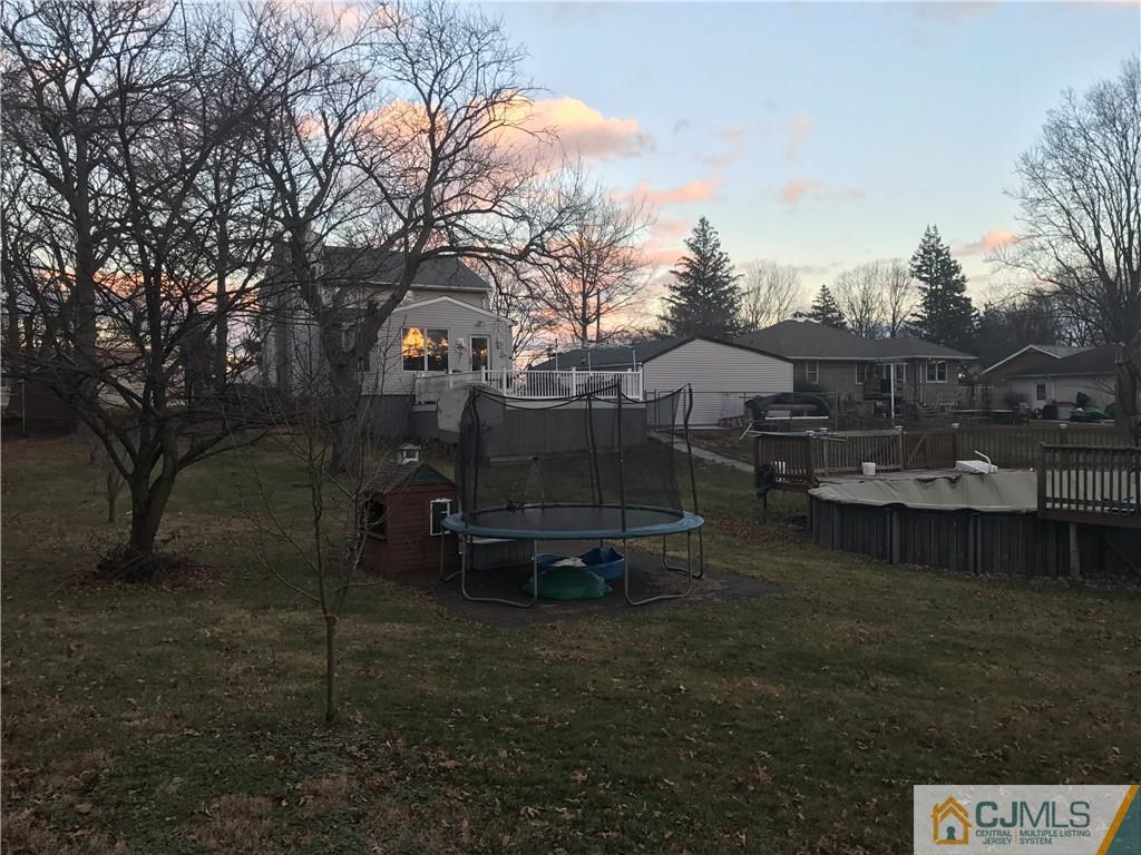 93 Magnolia Road Iselin, NJ 08830 - Photo 23 of 25 a view of a lake in front of house