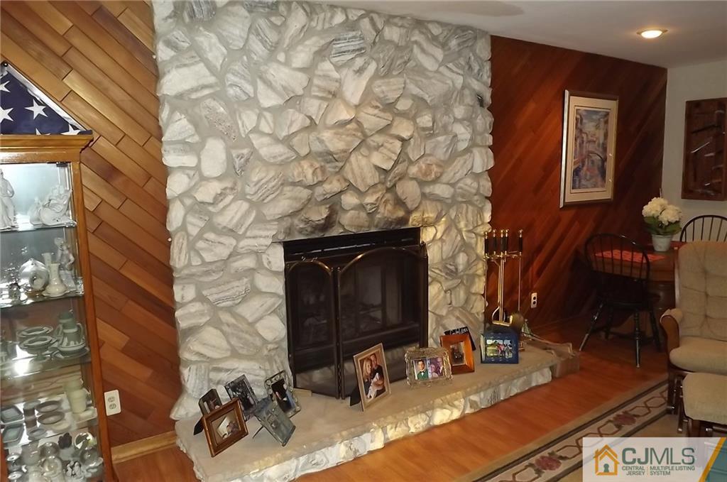 93 Magnolia Road Iselin, NJ 08830 - Photo 6 of 25 a room with fireplace furniture and a flat screen tv