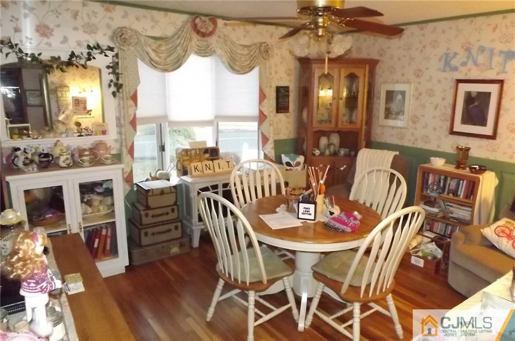 93 Magnolia Road Iselin, NJ 08830 - Photo 7 of 25 a dining room with furniture a chandelier and wooden floor