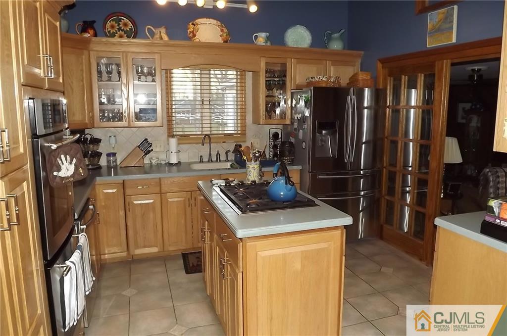 93 Magnolia Road Iselin, NJ 08830 - Photo 9 of 25 a kitchen that has a sink a stove and a window