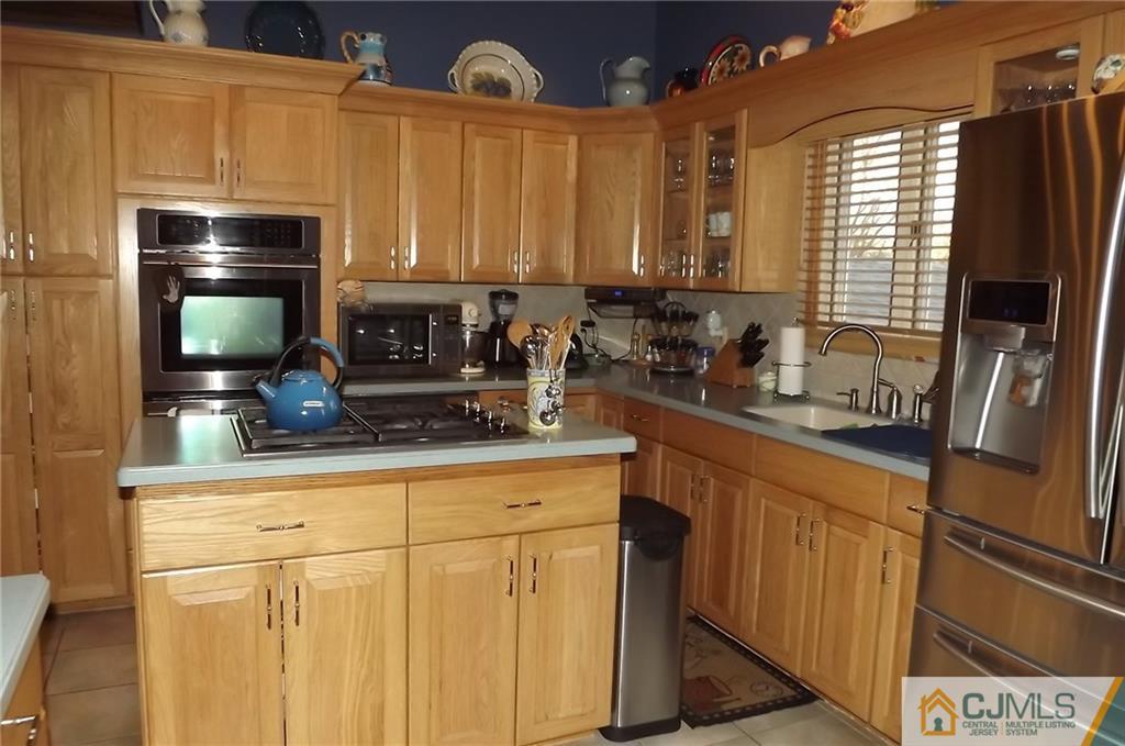 93 Magnolia Road Iselin, NJ 08830 - Photo 10 of 25 a kitchen with stainless steel appliances a sink and a refrigerator
