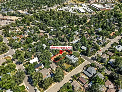 an aerial view of a houses with street