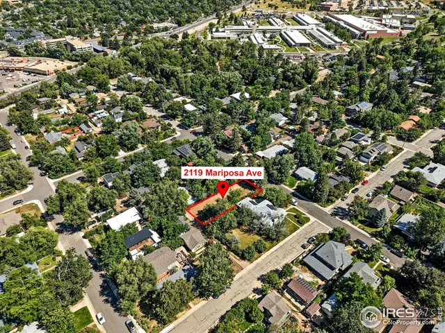 an aerial view of a houses with street