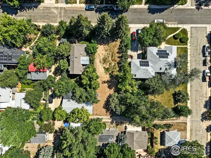 an aerial view of residential house with outdoor space and trees all around