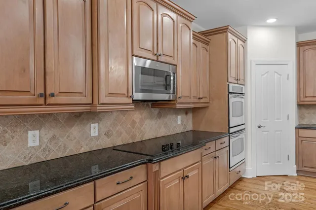a kitchen with appliances cabinets and a counter top space