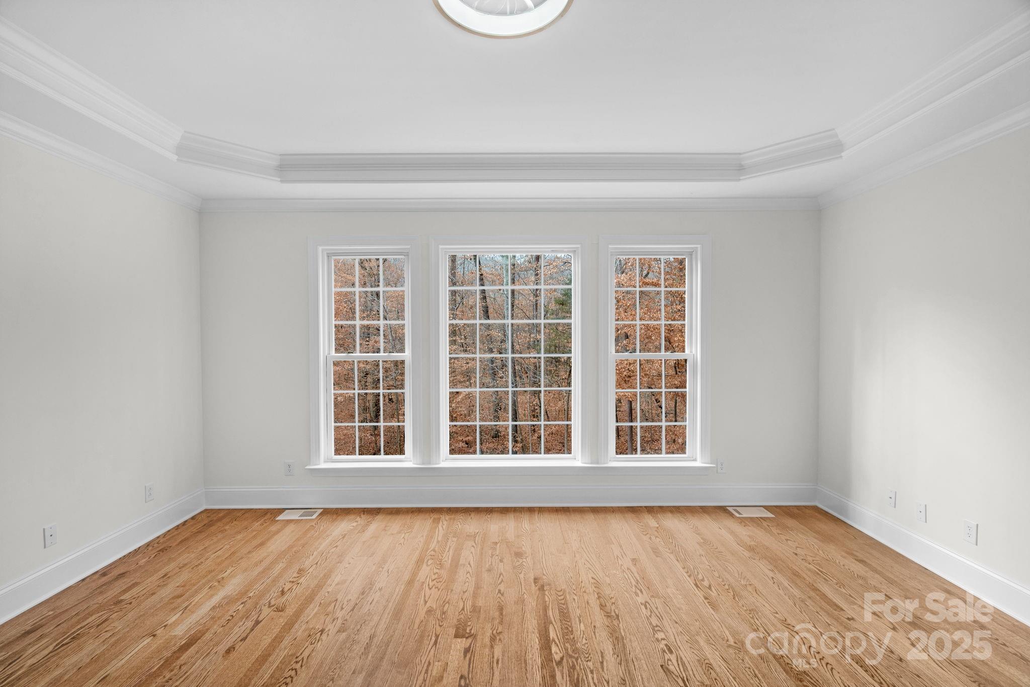 1300 Longleaf Court Weddington, NC 28104 - Photo 21 of 48 a view of an empty room with wooden floor and a window