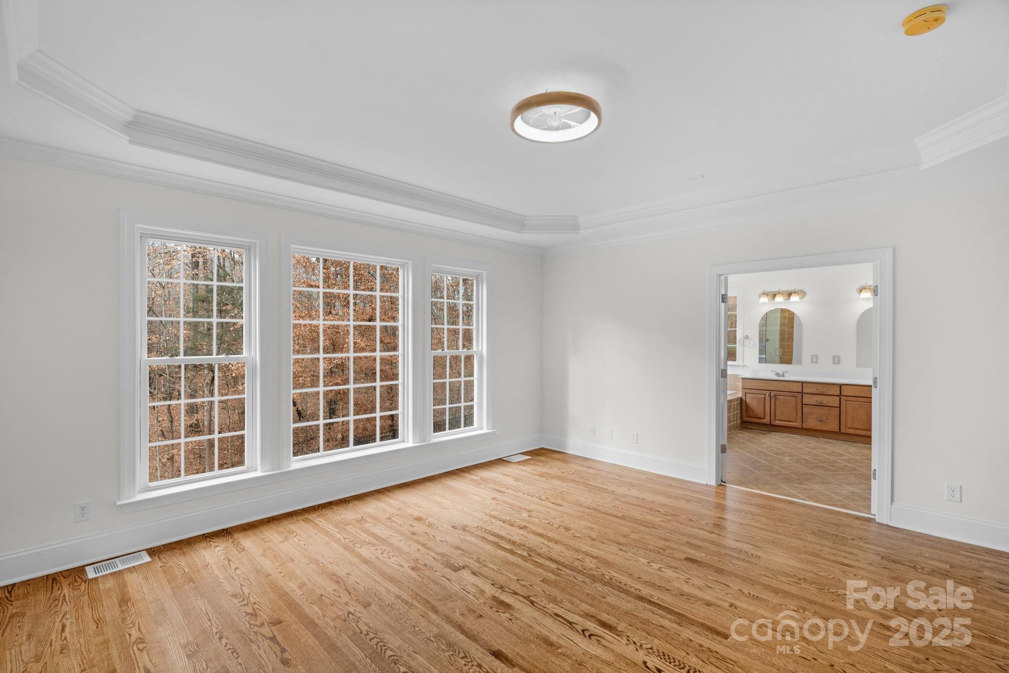 1300 Longleaf Court Weddington, NC 28104 - Photo 22 of 48 an empty room with wooden floor and windows