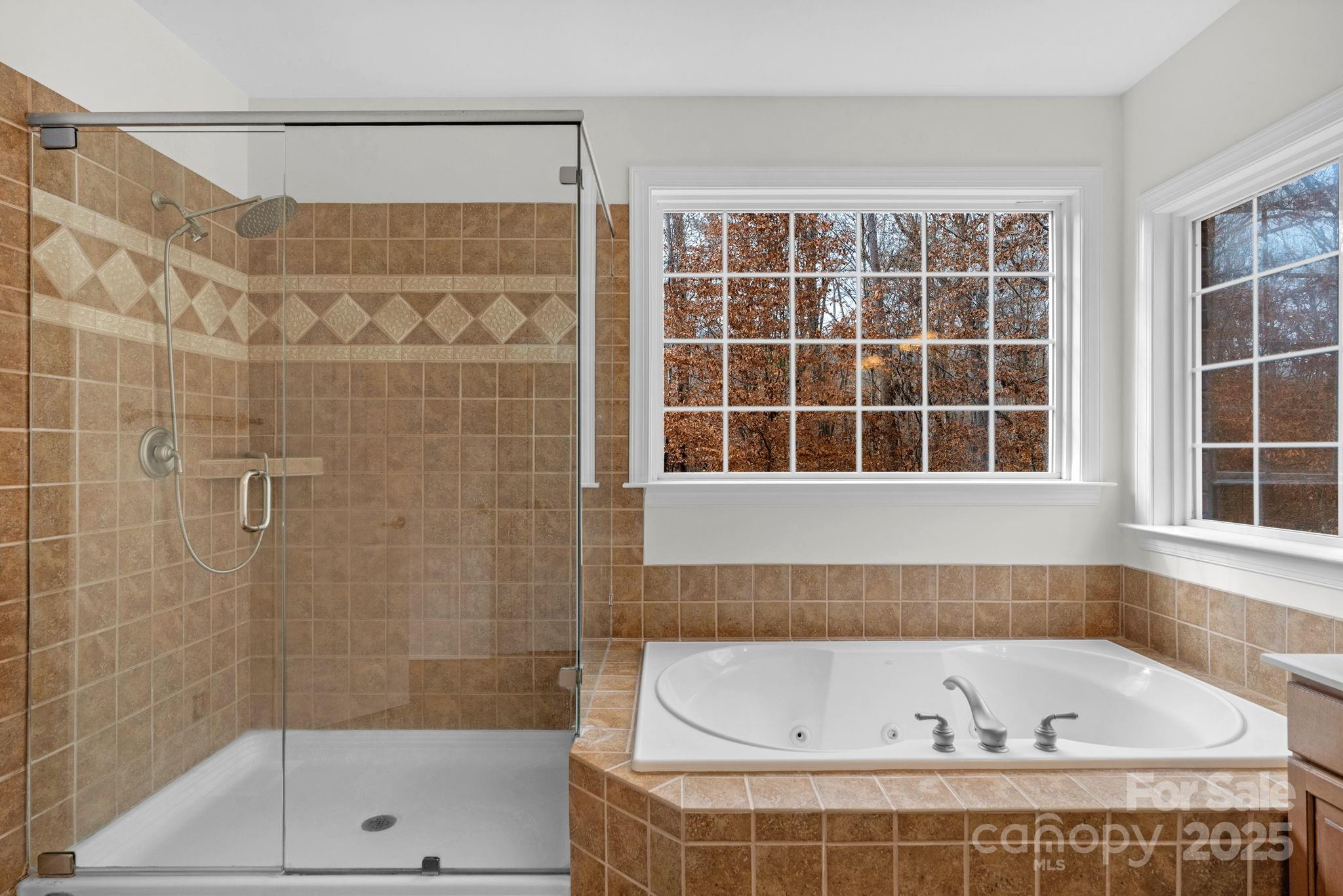 1300 Longleaf Court Weddington, NC 28104 - Photo 24 of 48 a bathroom with a bathtub and shower