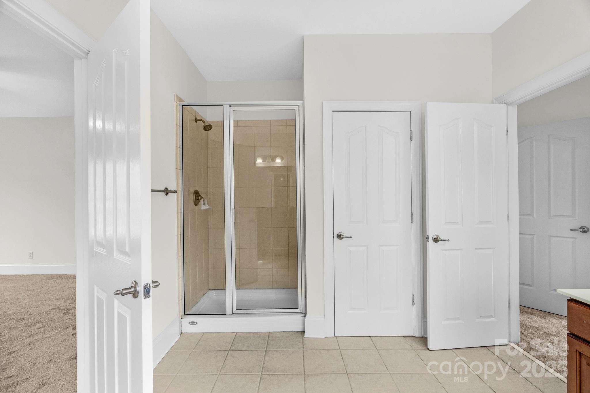 1300 Longleaf Court Weddington, NC 28104 - Photo 33 of 48 a view of a bathroom with a glass door shower